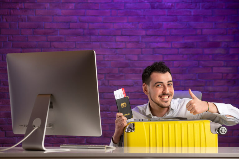front view office worker sitting his working place with tickets passport bag